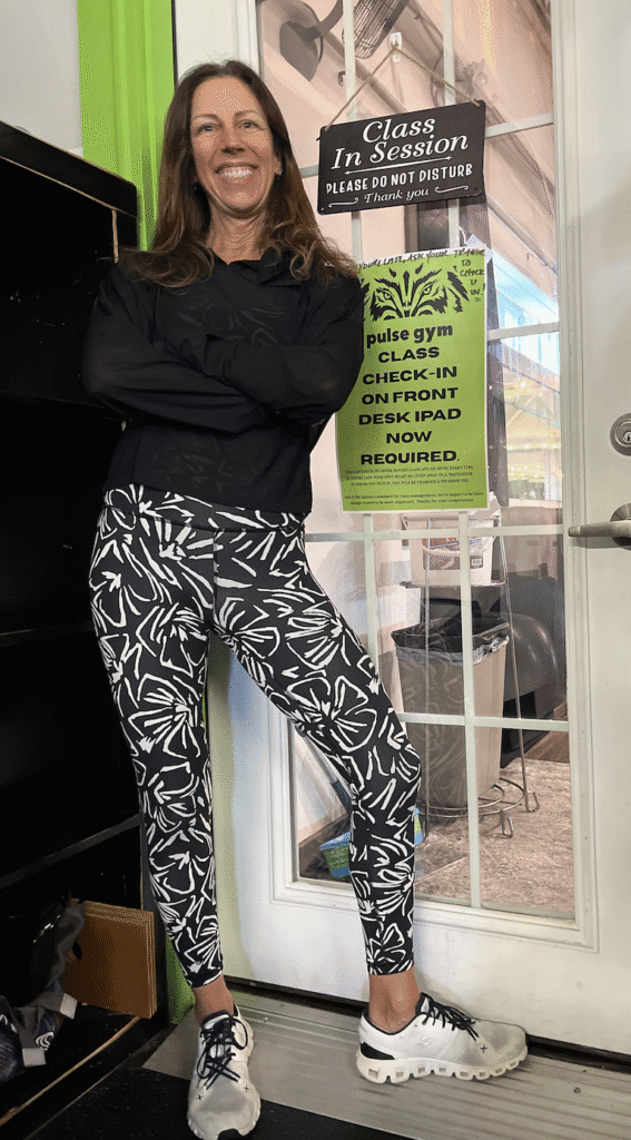 Person wearing black and white patterned pants and a black top.