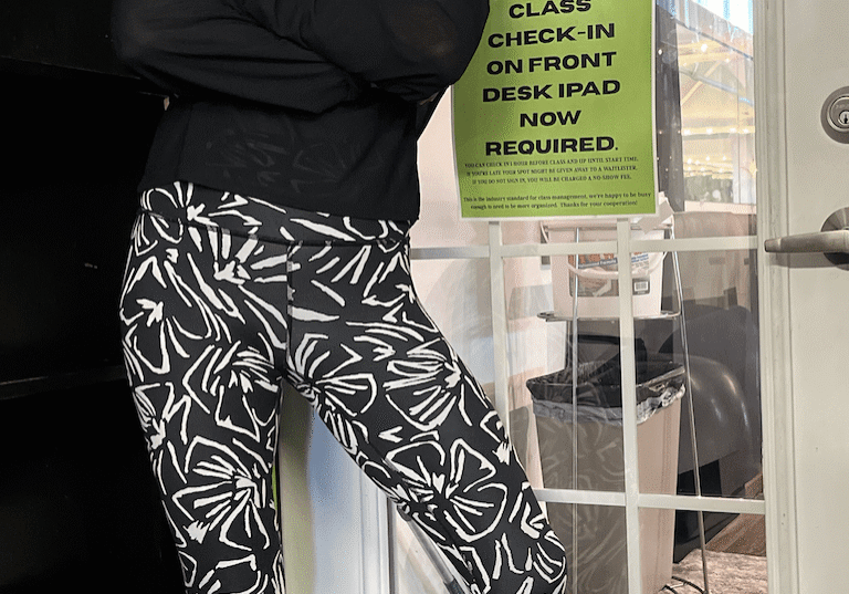 Person wearing black and white patterned pants and a black top.