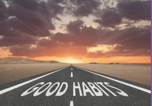 A road at sunset with 'GOOD HABITS' written on it.